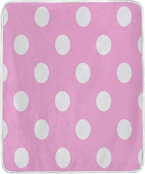 pink blanket with white polka dots
