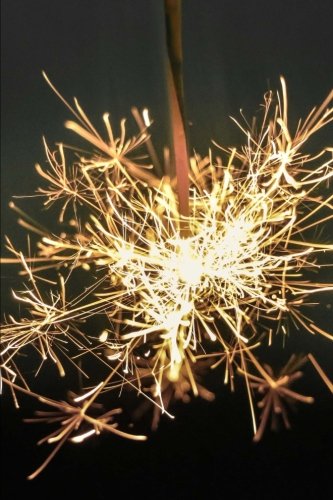 Bright glowing sparkler at night fireworks journal: 150…