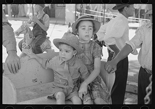 Spanish-American children waiting for a ride on the merry-go-round, Fiesta, Taos, New Mexico