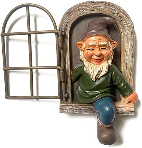 Colorful backyard gnome hanging from a tree branch.