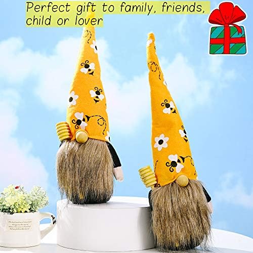 A 9-inch gnome figurine with a long white beard, holding a bee, sitting on a desk.