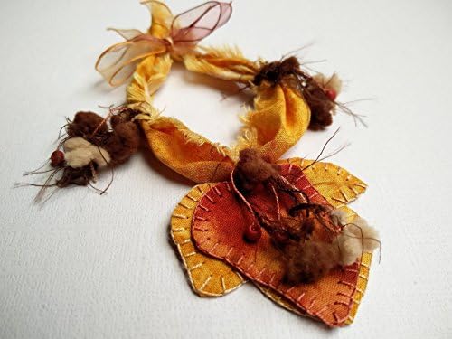 Fabric bracelet with embroidered orange leaf detail. Handmade. Textile jewelry by Evelyn Soto