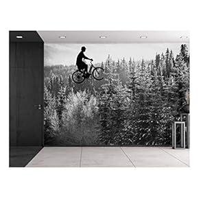 Guy on a Bike Flying Over a Pine Tree Forest in Grayscale - Wall Mural, Removable Sticker, Home Decor - 66x96 inches