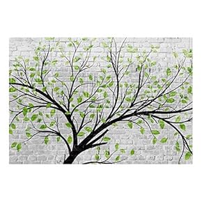 Tree with Green Leaves Going Along a Brickwall Wall Mural