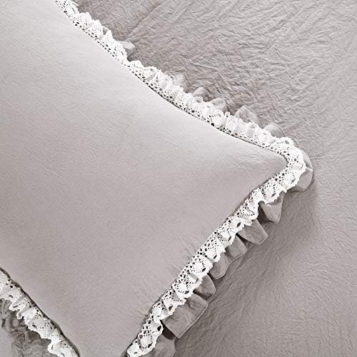 White lace ruffle comforter set displayed in a room.
