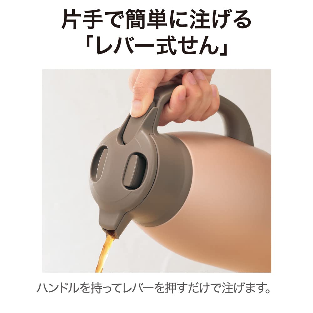 Person cleaning the disassembled parts of the Zojirushi vacuum bottle under running water