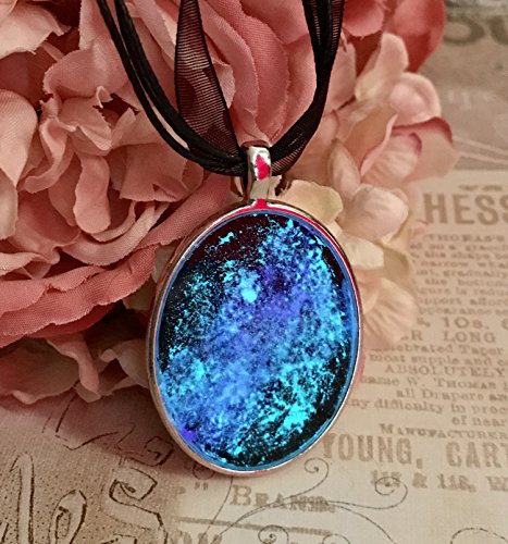 Glow in the dark galaxy and nebula pendant on black rib…