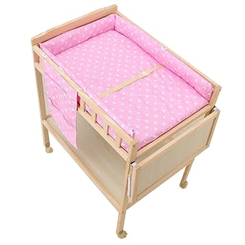 pink crib with changing table