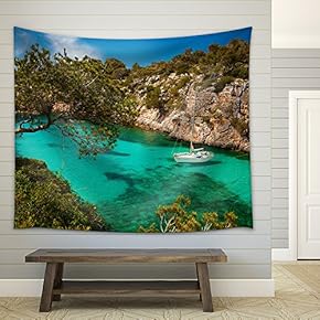 Small Yacht Floating in Azure Sea in The Village Cala Pi, Majorca, Spain - Fabric Wall Tapestry Home Decor - 51x60 inches