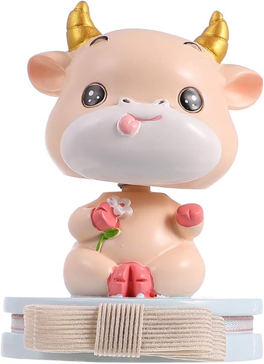 cow with toy car on head