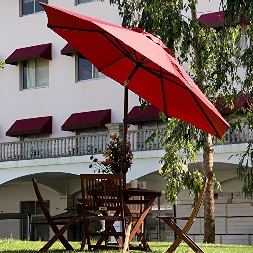A tilting patio umbrella shading a table