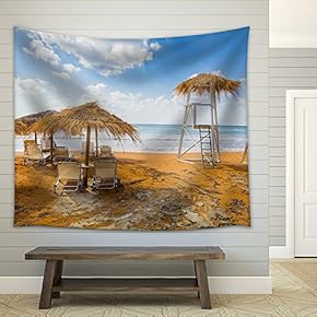 Sun Umbrellas Made of Dry Vegetation, Sun Beds and a Lifeguards 