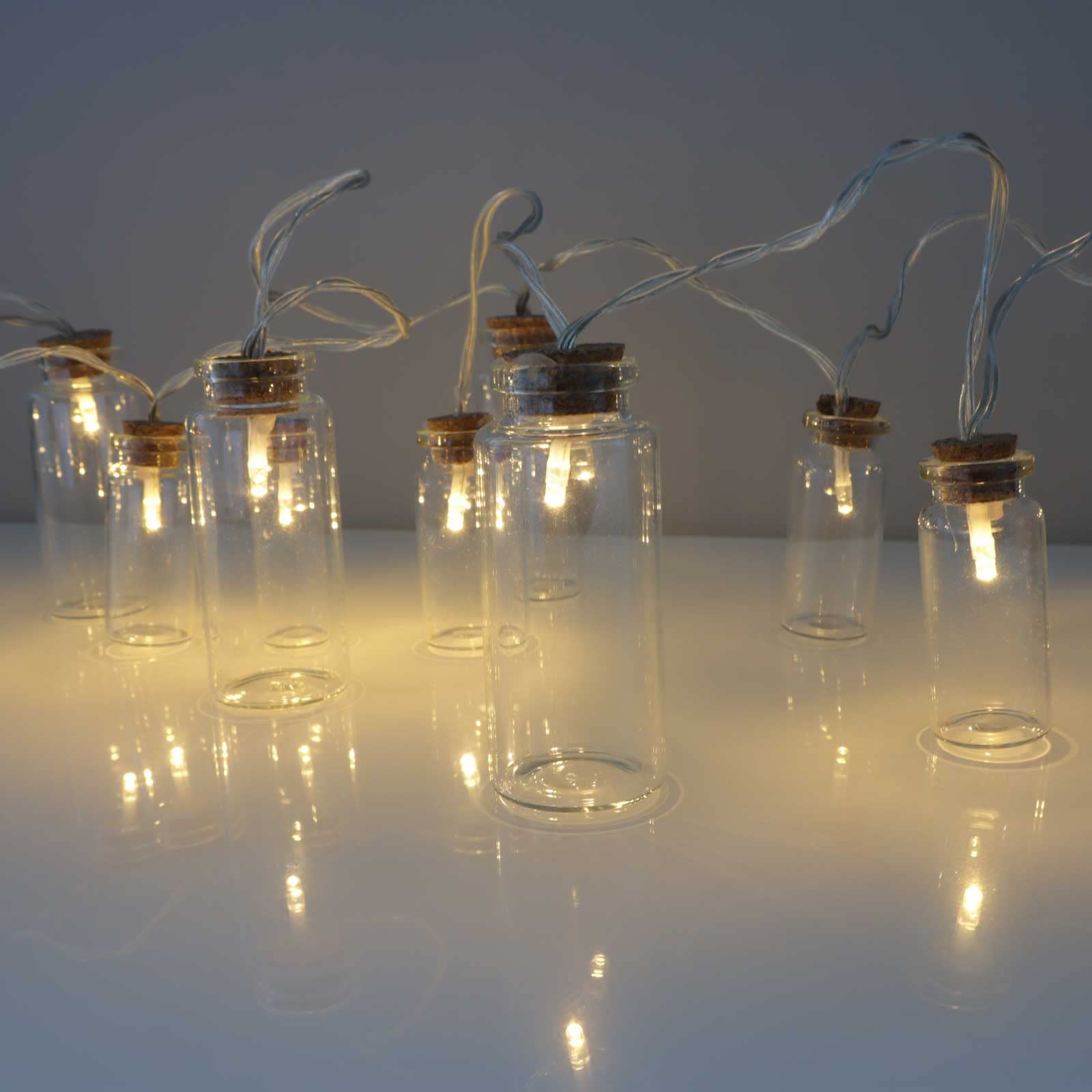 Qbis 16 Glass Jar Lights. Battery Powered Fairy Lights. String Lights with 16 Small Jars Each with a Warm White LED Inside and Cork Stopper. On/Off/Timer Modes. Indoor use. (Clear Jar Lights)