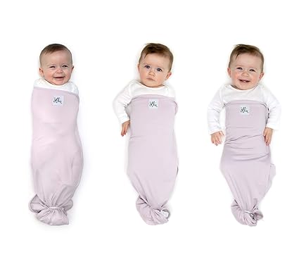 baby getting arms out of ollie swaddle