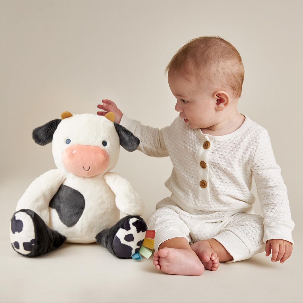 Itzy Ritzy Snuggles Plush Toy – Soft Stuffed Animal for Babies, Kids & Adults – Sensory Ribbons & Textured Fabrics for Tactile Play – Cozy & Cuddly Companion for Newborns & Up (Cow)