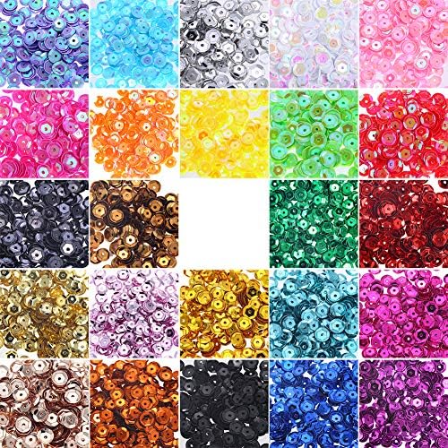 Colorful free sequins in various sizes displayed on a surface.