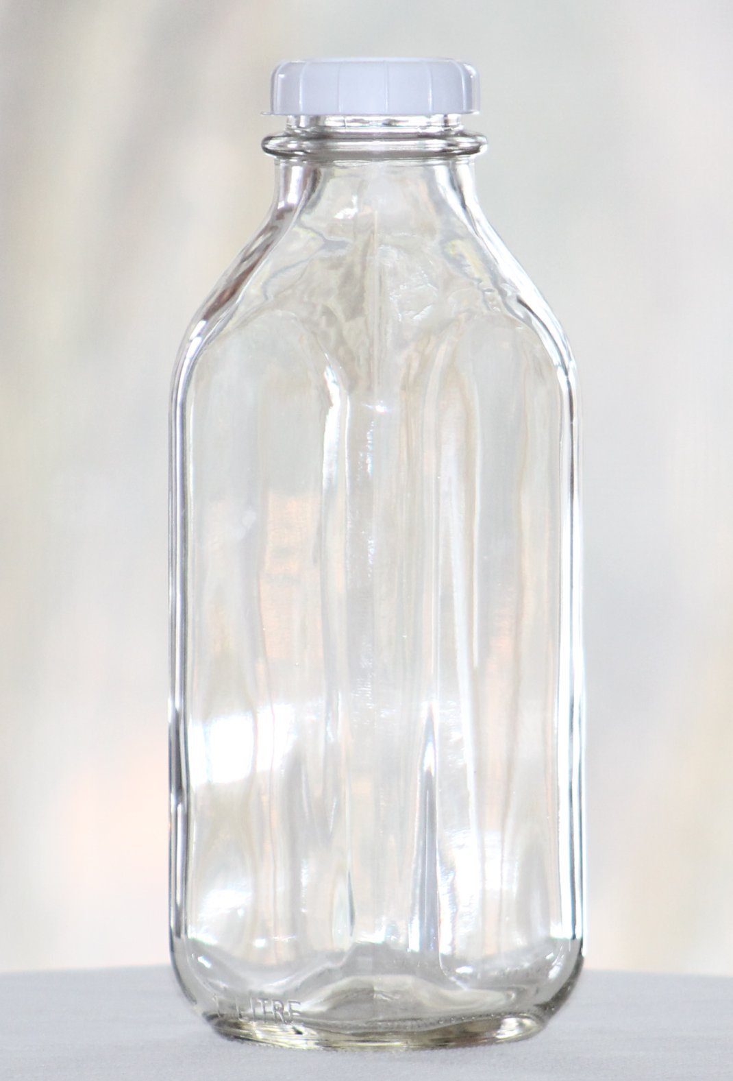 Glass Milk Bottles USA Made 33.8 oz Jugs with Extra Lids Set of 4