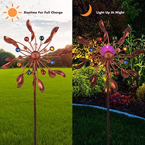 Colorful solar wind spinner rotating in a garden setting.