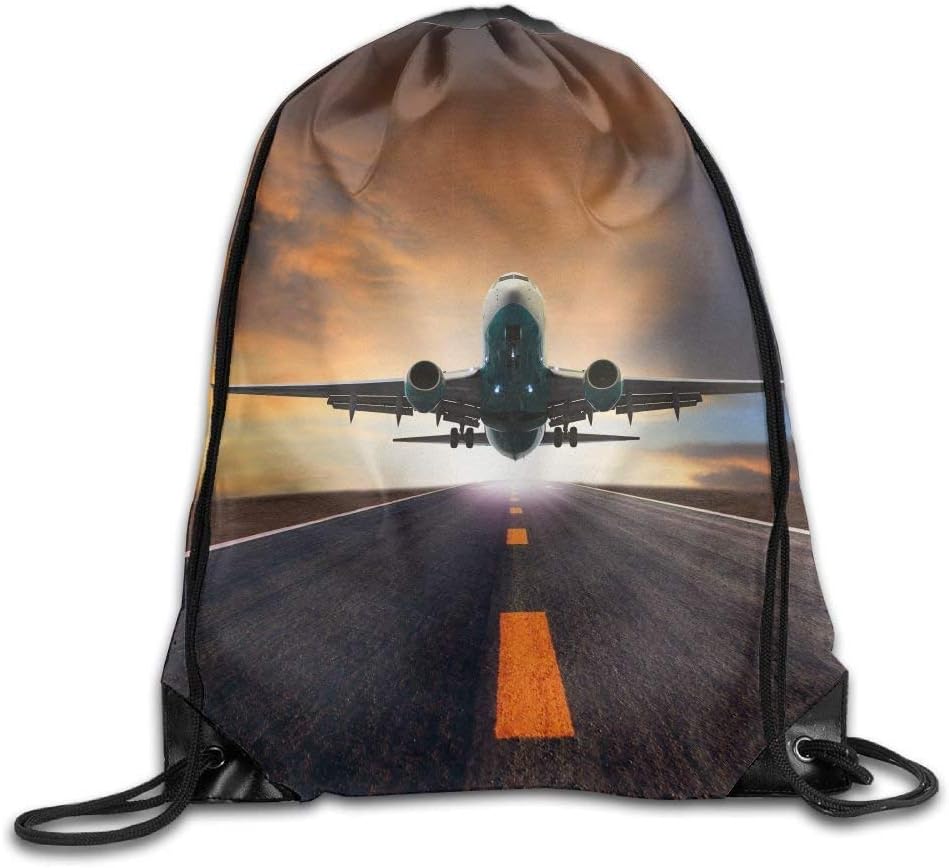 Passenger Jet Plane Flying Over Airport Runway Against Beautiful Dusky