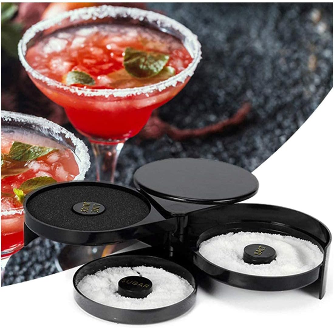 open three tier bar glass rimmer on a dark stone counter next to a salt-rimmed red cocktail garnished with lime