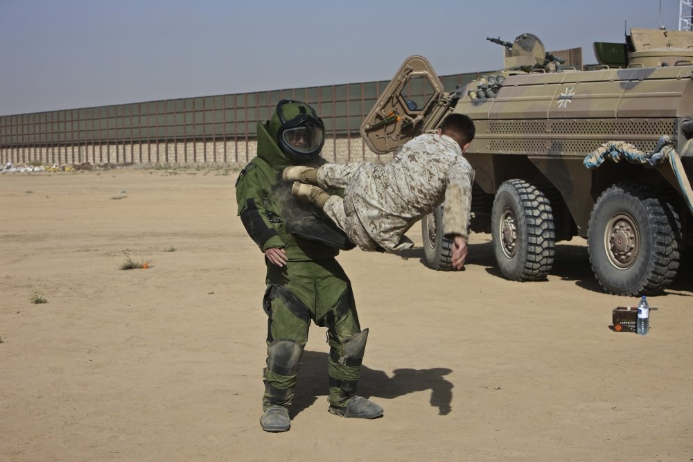 Posterazzi Kunduz Afghanistan flyng kick to the throat of another U.S. Marine in an EOD bomb suit. P