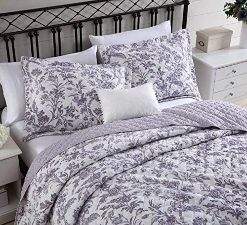 Colorful cotton quilt set with shams, includes care instructions.