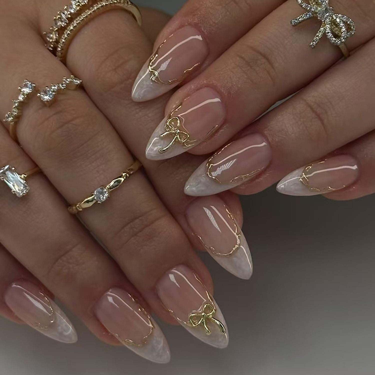Photo 1 of Gold Bow Press on Nails Medium Almond Press on French Tip Fake Nails White Smudge False Nails with 3D Golden Lines Designs Artificial Nails Nude Full Cover Stick on Nails for Women Decor Supply 24Pcs