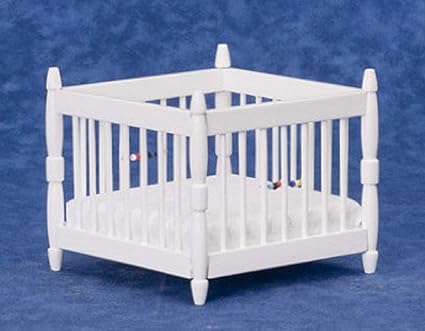 white wooden playpen