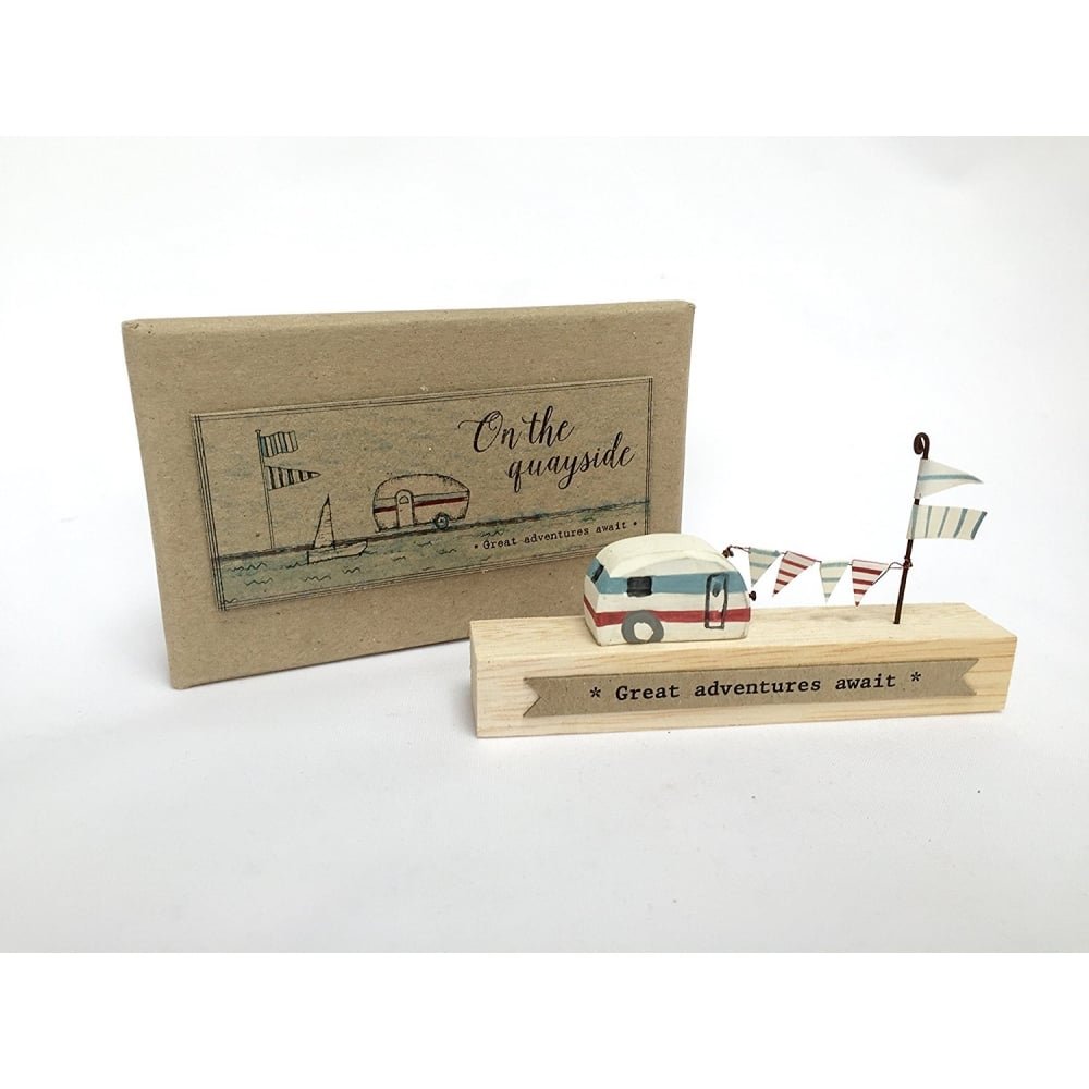 on the quayside great adventures await wooden caravan