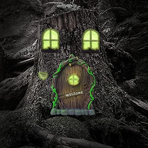 Fairy garden door glowing on tree in backyard.