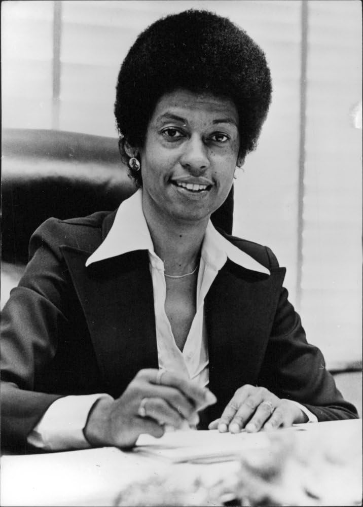 Vintage photo of Eleanor Holmes Norton at her desk, in her office.