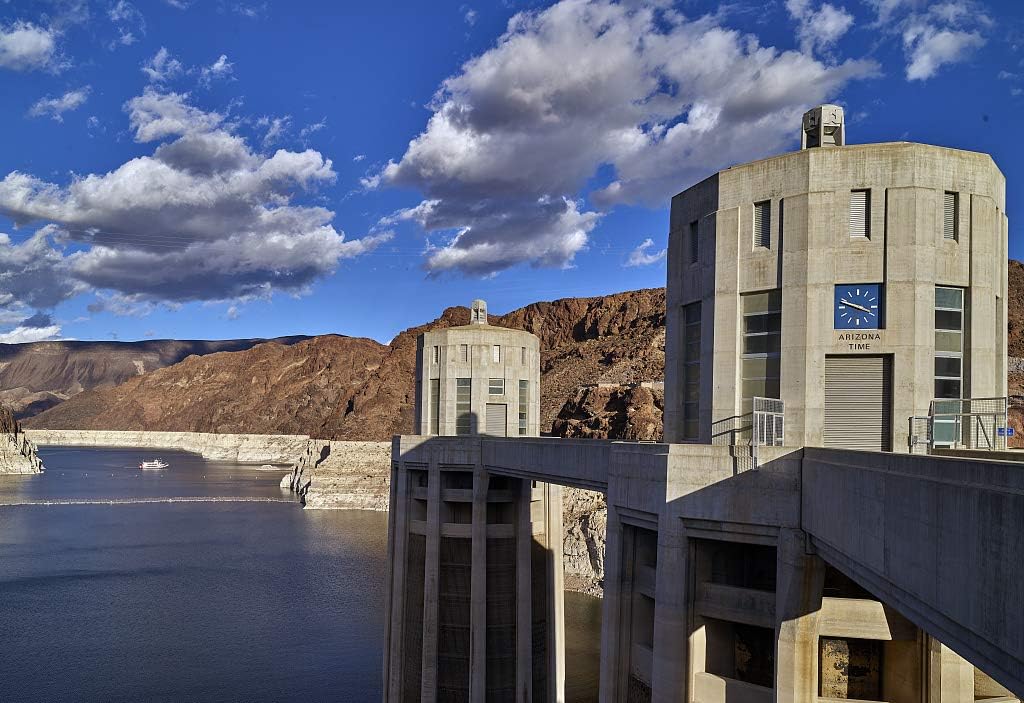 24 x 36 Giclee print of&nbsp;Two of four 338-foot-high intake towers, the nearest of which showing the current time in Arizona, that stand in the deep waters of Lake Mead behind massive Hoover Dam, wh 34y