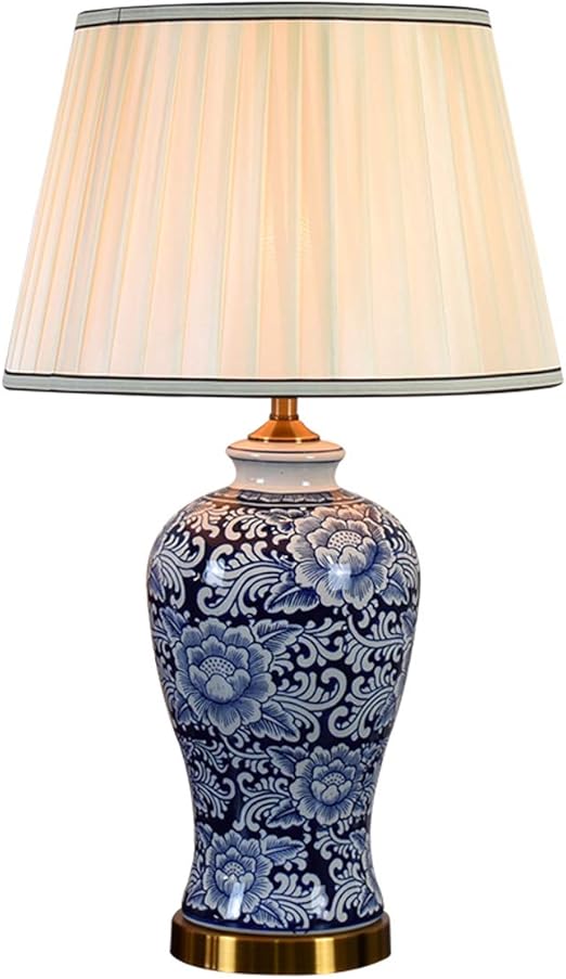 white ceramic lamp with flower on base