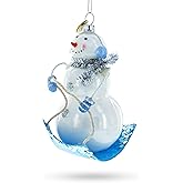 Snowman Riding a Sled Blown Glass Christmas Ornament