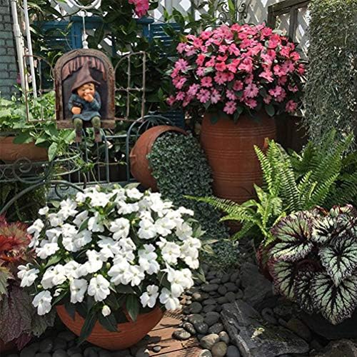 A humorous garden gnome ornament standing next to a tree.