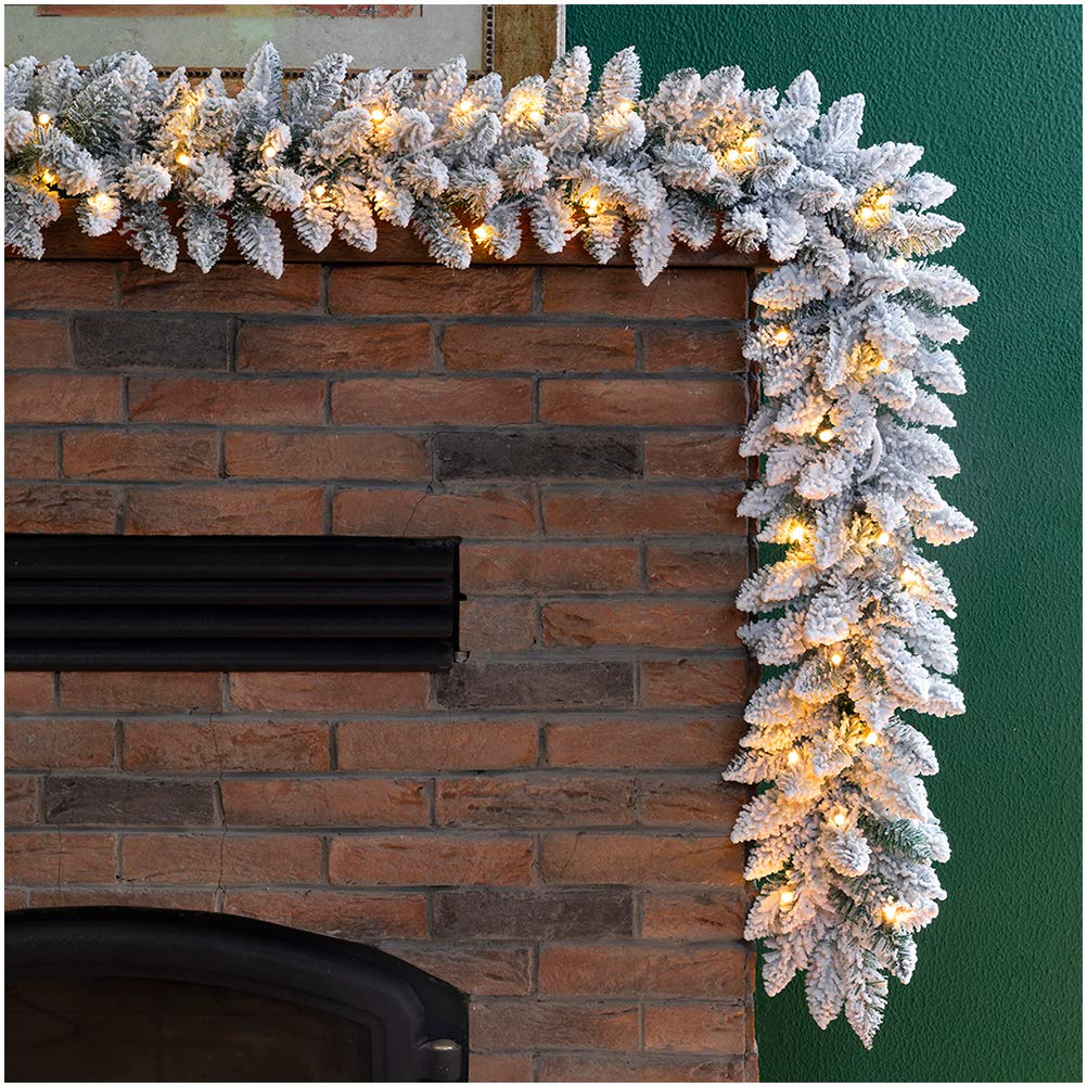 Photo 1 of ***(HEAVILY USED/ MINOR DAMAGE)***Glitzhome 9ft Christmas Garland for Mantle, Pre-Lit Snow Flocked Christmas Garland with Warm White LED Lights and Timer for Fireplace, Dining Table, Stairs Christmas Decoration BATTERY OPERATED