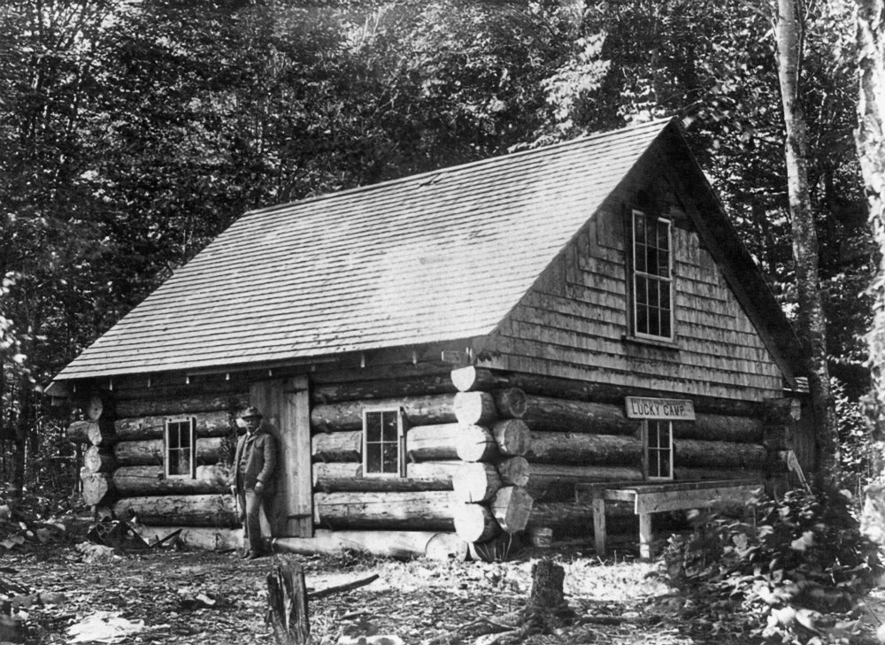 Amazon Com Maine Log Cabin Na Man Standing In Front Of A Log