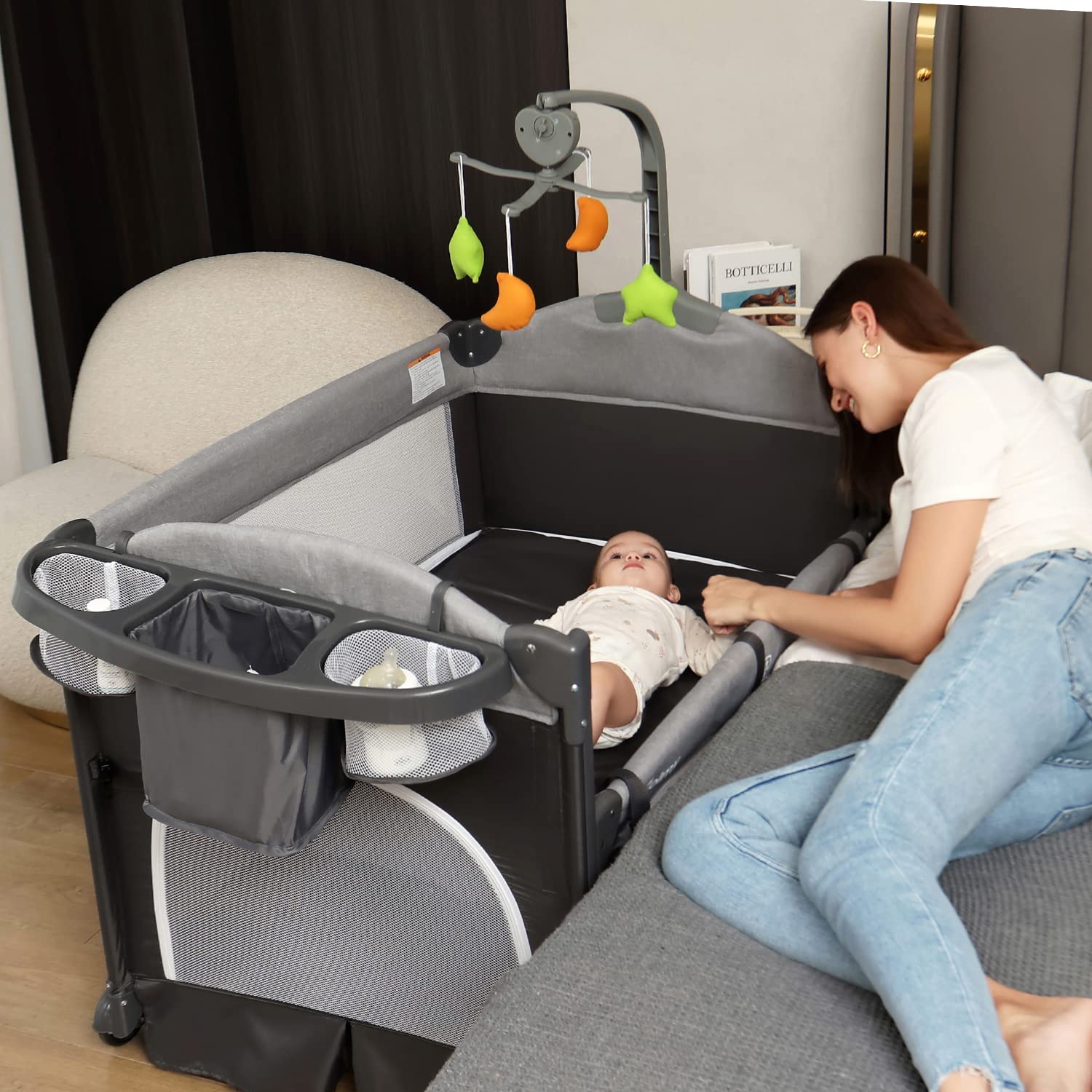 Photo 1 of Zdolmy Baby Bedside Sleeper Bassinet, 4-in-1 Pack and Play with Bassinet w/Diaper Changing Table & Storage Bag, 3 Adjustable Heights, Toy Arch & Music, Portable Baby Play Yard with Carry Bag