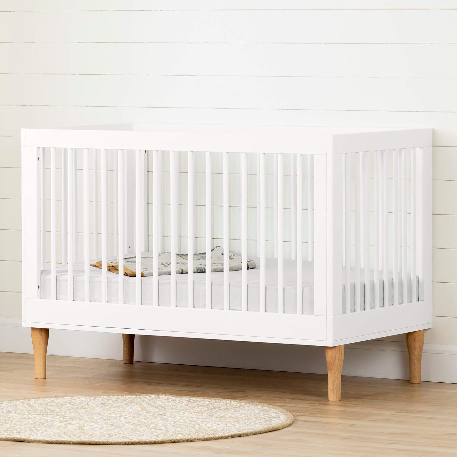 white and walnut crib