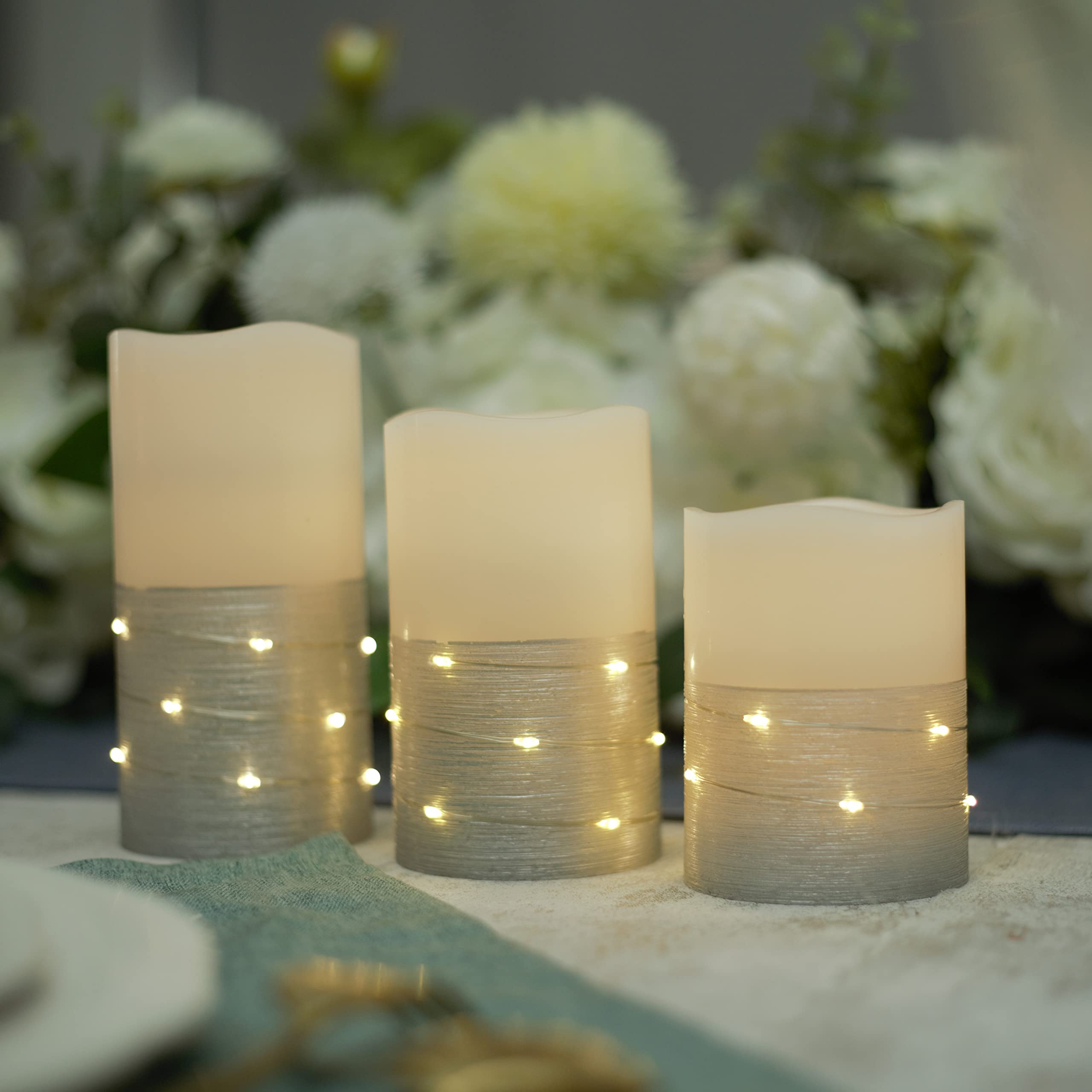 Photo 1 of H-BLOSSOM Flickering Flameless Candles Ivory Real Wax Pillar with Embedded String Lights LED Candles Battery Operated with 10 Key Remote and Cycling 5H Timer Set of 3 (3" x 4"/5"/6") (Silver)