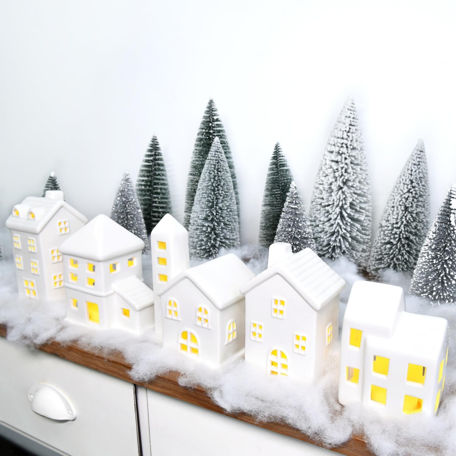 Photo 1 of JETEHO Ceramic Christmas Village Houses 5 Pcs White Houses & 9 Pcs Trees & Fake Snow Farmhouse Christmas Decorations Indoor for Home Table Mantle Fireplace