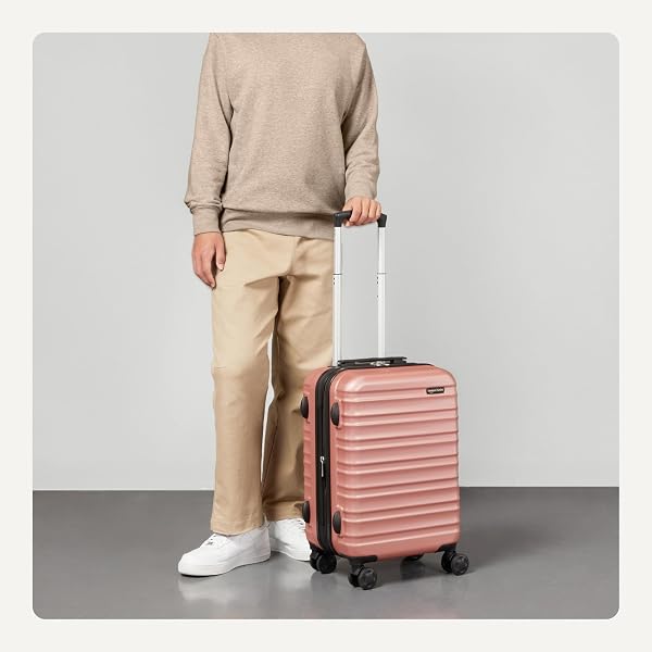 AMAZON BASICS 21″ HARDSIDE CARRY-ON LUGGAGE WITH MULTI-DIRECTIONAL WHEELS, EXPANDABLE FOR UP TO 25% MORE SPACE, SCRATCH-RESISTANT SURFACE, ROSE GOLD