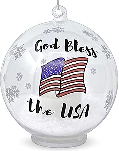 BANBERRY DESIGNS Patriotic Christmas Ornament – Glass Ball Ornament with God Bless The USA – Light Up Ornament with a LED Candle and Artificial Snow Inside – Red White and Blue American Flag Design