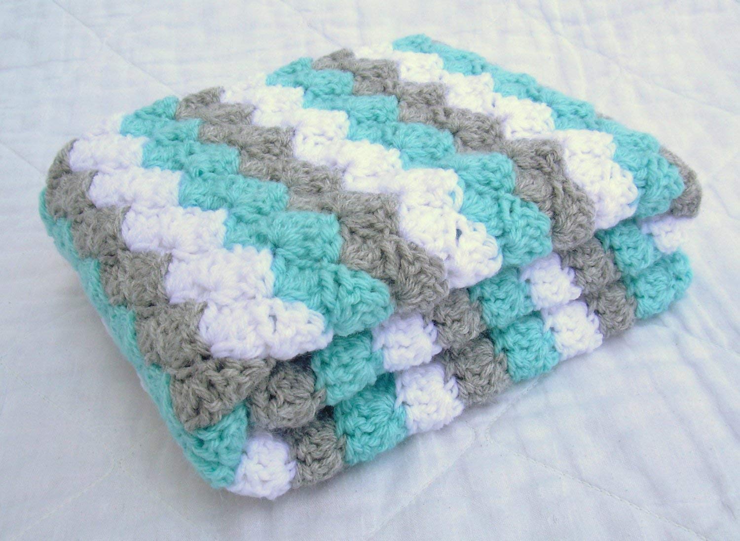 grey and white crochet baby blanket