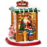 MOMENTS IN TIME Lighted Santa&rsquo;s Christmas Village Shop LED Lights, Music &amp; Animation Battery Operated 8.8&rdquo; Holiday Building Christmas Decoration