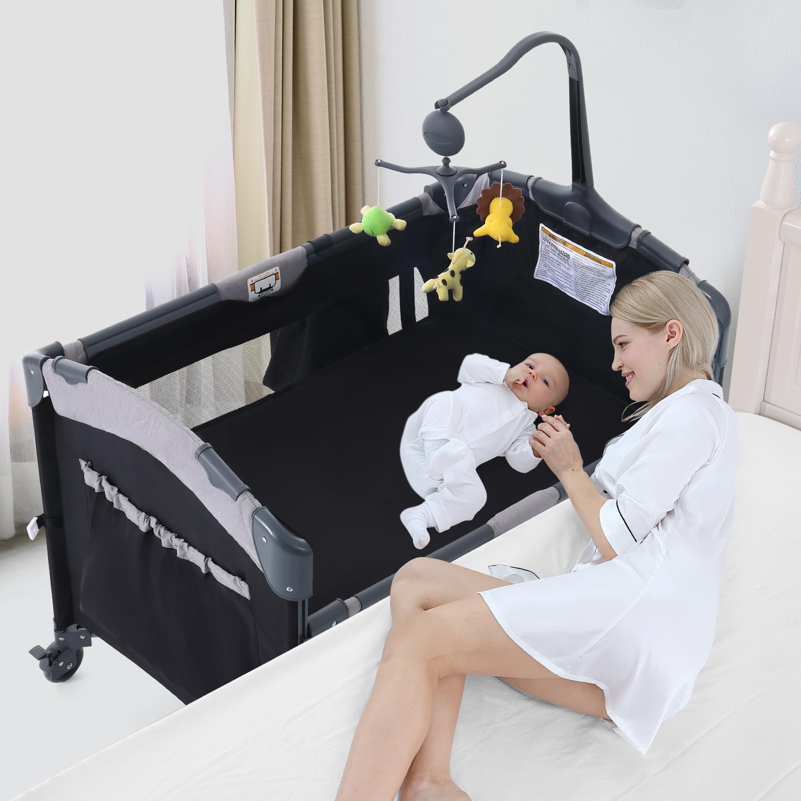 Photo 1 of Jaoul 5 in 1 Baby Crib, Bassinet Beside Sleeper, Pack and Play with Bassinet and Changing Table Portable Travel Baby Playpen with Toys & Music Box, Mattress for Girl Boy Infant Newborn Black