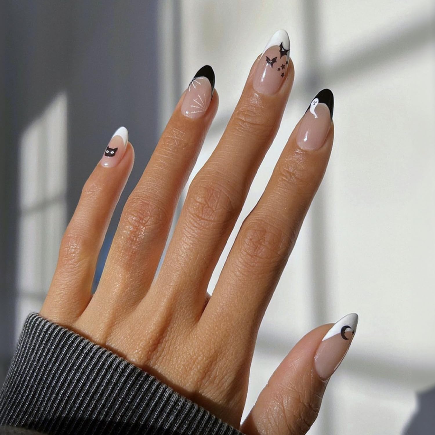 Photo 1 of Halloween Press on Nails Almond Fake Nails with Stars Moon Bat Cat Designs Stick on Nails Black White French Tip Acrylic Artificial Nails for Women Girls False Nail Decorations24pcs