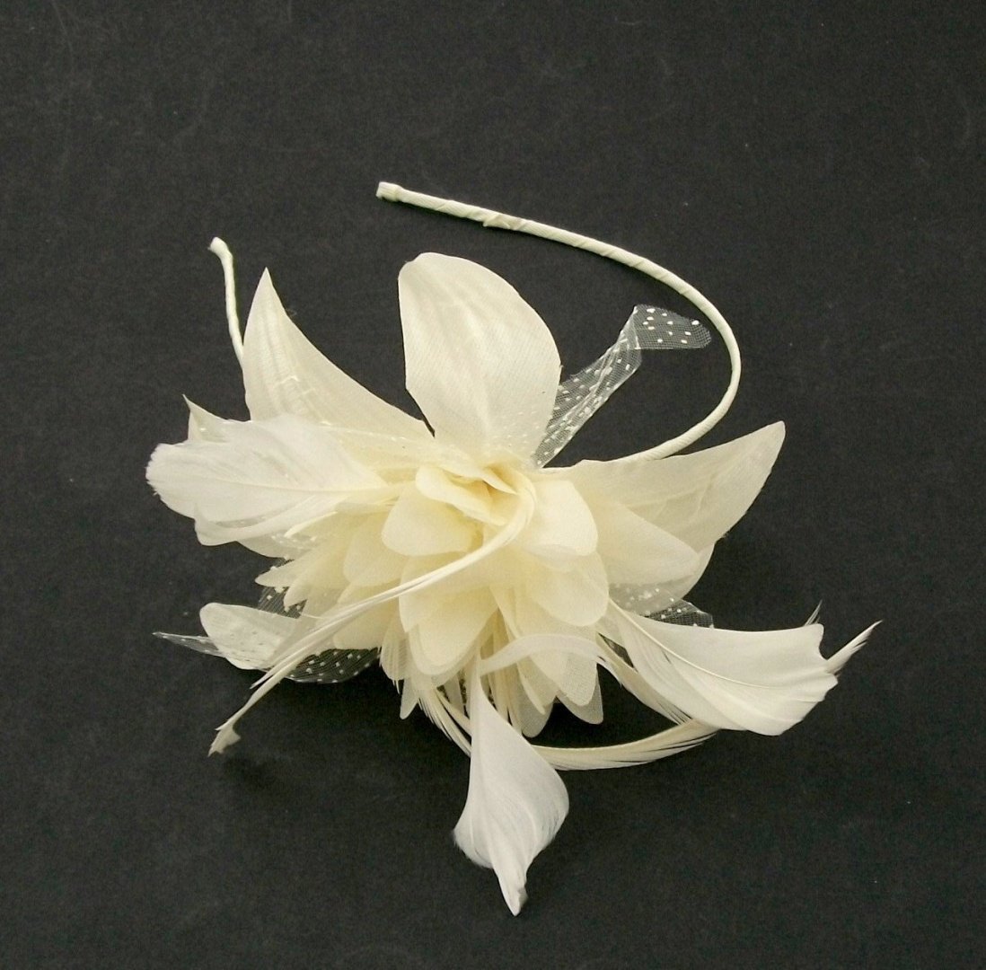 Ivory cream and off white silk flower and feather hair fascinator mounted on a band