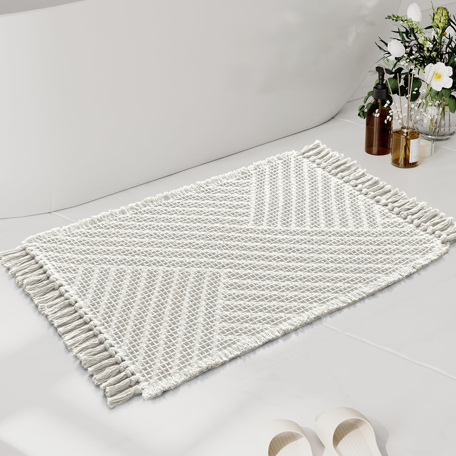 Photo 1 of H.VERSAILTEX Waffle Bath Mat Super Absorbent Boho Bath Mat Non Slip Bath Rugs for Bathroom Floor Machine Washable Dry Fast Bathroom Rugs with Tassels, 24" x 36", Ivory White