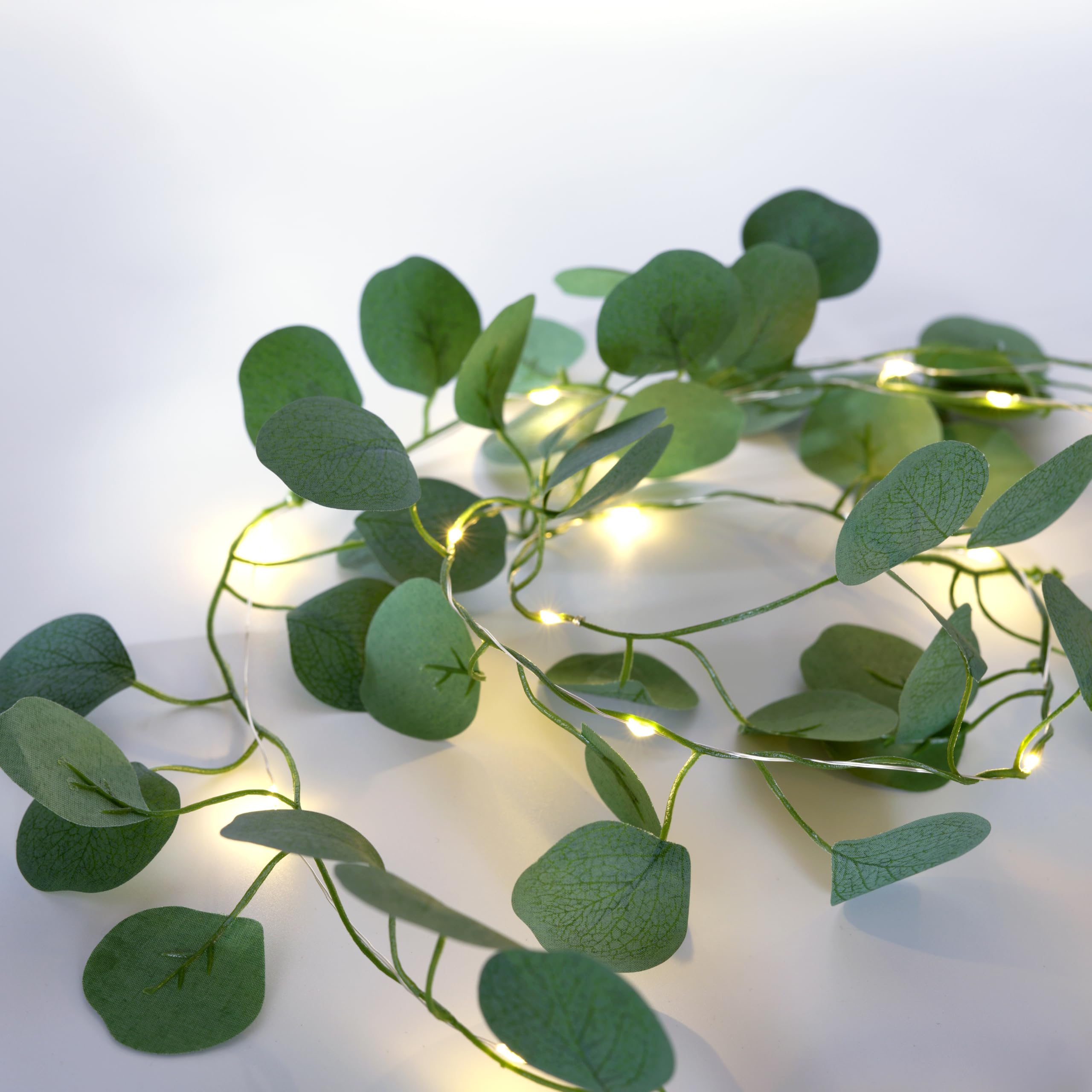 Photo 1 of Hoolight Artificial Eucalyptus Leaves Foliage String Lights 6.6Ft 20 LED Fairy Leaf Lights Warm White Greenery Vines Garland and Table Runner, Battery Operated Wedding Backdrop Wall Decor